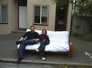 Carol and Jackson sitting on a futon